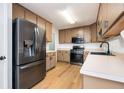 Efficient kitchen featuring stainless steel appliances, updated countertops, and ample cabinet space at 409 Cold Springs Ln, Mcdonough, GA 30252