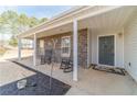 Inviting front porch with stone accents and two rocking chairs, perfect for relaxing outdoors at 704 Stonecrest Ln, Loganville, GA 30052