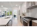 Contemporary kitchen featuring stainless steel appliances, quartz countertops, and a seamless flow into the living space at 775 Juniper St # 405, Atlanta, GA 30308