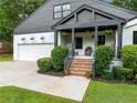 Inviting covered front porch with brick steps, updated lighting, and great curb appeal at 916 Stratford Rd, Avondale Estates, GA 30002