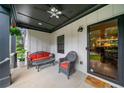 Relaxing front porch area with comfortable seating, ceiling fan, and modern door at 916 Stratford Rd, Avondale Estates, GA 30002