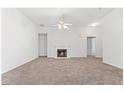 Spacious living room with plush carpeting and a cozy fireplace at 10231 Deep Creek Pl, Union City, GA 30291
