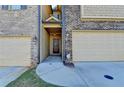 Inviting front entrance with a covered porch, sidelights, and an attached garage, offering curb appeal at 4421 Fulson Dr, Lilburn, GA 30047