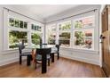 Bright dining area with a glass table, modern chairs, and large windows overlooking the street at 653 N Highland Ne Ave # 5, Atlanta, GA 30306