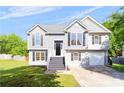 Charming two-story home featuring a well-maintained lawn, garage, and classic architectural details at 7186 Raintree Loop, Jonesboro, GA 30236