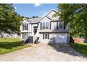Inviting two-story home with gray siding, black shutters, manicured lawn, and an attached one car garage at 7186 Raintree Loop, Jonesboro, GA 30236