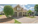 Charming home featuring a brick driveway, two-car garage, and well-maintained front yard at 308 Rusty Gate Pass, Woodstock, GA 30189