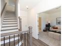 Welcoming entryway with a staircase and open view into the living area, creating a warm and inviting atmosphere at 506 Healy Dr # 74, Cumming, GA 30040