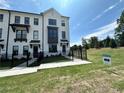Attractive townhome with black accents, and a well-maintained lawn, offering a blend of style and comfort at 506 Healy Dr # 74, Cumming, GA 30040