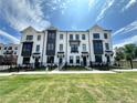 Charming townhome featuring a modern facade and well-manicured lawn, perfect for comfortable and stylish living at 506 Healy Dr # 74, Cumming, GA 30040