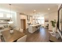 Bright, open-concept kitchen with stainless steel appliances, white cabinets, a large island, and adjacent dining area at 506 Healy Dr # 74, Cumming, GA 30040