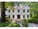 Charming two-story home featuring a well-manicured front yard and a brick exterior at 55 Bransford Rd, Sandy Springs, GA 30324