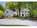 Charming two-story home featuring a well-manicured front yard and a brick exterior at 55 Bransford Rd, Sandy Springs, GA 30324