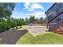 Backyard with stone patio, fire pit and lush landscaping offers a private outdoor space at 429 Oakland Ave, Atlanta, GA 30312