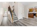 Bright foyer with hardwood floors, staircase, and an open view to the kitchen at 2957 Smith Ridge Trce, Peachtree Corners, GA 30071