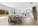 Bright and airy dining area with modern table set and a view of the outdoor patio and living room at 7169 Brushwood Bend - Lot 37, Lithonia, GA 30058