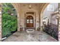 Inviting front porch with arched brick entryway, double doors, and decorative stone flooring at 89 Somerset Ln, Cartersville, GA 30121