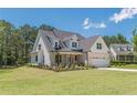 Charming two-story home with a brick and siding facade, well-manicured lawn, and a two-car garage at 4075 O Henry Ct, Mcdonough, GA 30252