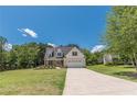 Charming two-story home with a brick and siding facade, well-manicured lawn, and a two-car garage at 4075 O Henry Ct, Mcdonough, GA 30252