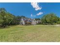 Expansive green lawn with a charming two-story home featuring a brick and siding facade and an attached garage at 4075 O Henry Ct, Mcdonough, GA 30252