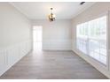 The dining room is bright with elegant wainscoting, neutral walls, and vinyl floors at 436 Crestmont Ln, Canton, GA 30114