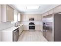 Bright kitchen with stainless steel appliances, modern white countertops and backsplash, plus wood floors at 436 Crestmont Ln, Canton, GA 30114