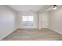 Bright living room features neutral walls, hardwood flooring, and natural light from the window at 436 Crestmont Ln, Canton, GA 30114