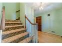 Traditional carpeted staircase with wooden handrail and trim, leading to the upper level of the home at 5166 Vivid Dr, Stone Mountain, GA 30087