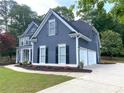 Stylish home showcasing a side entry garage, lush lawn, and a well-maintained exterior at 219 Maple Creek, Woodstock, GA 30188