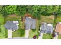 Aerial view of a home with a driveway, lush greenery, and neighboring properties, showcasing the landscape at 2949 Spotted Pony Nw Ct, Acworth, GA 30101