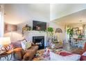 Cozy living room with a fireplace, plush seating, and plenty of natural light at 3006 Durban Ct, Decatur, GA 30034