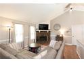 Cozy living room features a stone fireplace, vaulted ceiling, and a comfortable sectional sofa at 510 Whistlestop Dr, Woodstock, GA 30189