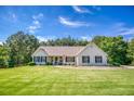 Charming home with well-maintained lawn, manicured bushes, and classic architecture on a sunny day at 1015 Carriage Way, Loganville, GA 30052