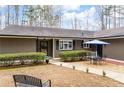 This home boasts a serene outdoor seating area and lovely, low-maintenance landscaping at 2796 County Line Rd, Acworth, GA 30101
