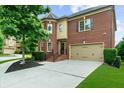 Charming brick home with a well-manicured front yard and attached two-car garage at 3086 Frazier Walk, Decatur, GA 30033