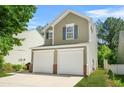 Charming two-story home featuring a two-car garage and neat landscaping, with driveway at 3454 Carriage Chase Rd, Atlanta, GA 30349