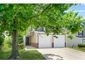 Charming two-story home featuring a two-car garage with large tree in the front yard at 3454 Carriage Chase Rd, Atlanta, GA 30349