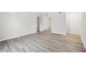 Neutral living room with wood-look flooring, base molding, and light gray walls at 5560 Kingsport Ne Dr # 27, Atlanta, GA 30342