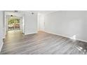 Light-filled living area with patio access and neutral walls with wood-look flooring at 5560 Kingsport Ne Dr # 27, Atlanta, GA 30342