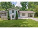 Charming home with lush green lawn and landscaping at 1585 Melanie Ct, Decatur, GA 30032