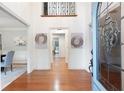 Bright foyer with gleaming hardwood floors and a view of the dining room and hall at 4429 Windsor Oaks Cir, Marietta, GA 30066
