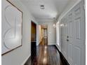Inviting foyer with hardwood floors, modern lighting fixture, and direct access to multiple rooms at 3070 Ascot Ln, Roswell, GA 30076