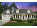 Charming two-story home with a welcoming front porch, two-car garage, and beautiful landscaping at 1624 Glenfield Dr, Lawrenceville, GA 30043
