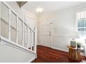 Inviting foyer featuring hardwood floors, a staircase, and a convenient coat closet at 1624 Glenfield Dr, Lawrenceville, GA 30043