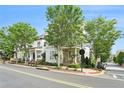 Street view of a quaint two-story home with mature trees enhancing its curb appeal on a sunny day with blue skies at 169 Waterman Se St, Marietta, GA 30060