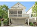 View of the back exterior featuring a screened porch, balcony and a two-car garage underneath at 169 Waterman Se St, Marietta, GA 30060