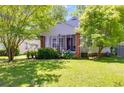 Charming home featuring a screened porch, brick pillars, lovely landscaping and a well-manicured lawn at 1834 Broad Ave, Atlanta, GA 30344