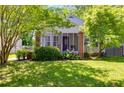 Charming home featuring a screened porch, brick pillars, lovely landscaping and a well-manicured lawn at 1834 Broad Ave, Atlanta, GA 30344