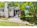 Rear view of home with a screen door, brick details, siding and lush green grass at 1834 Broad Ave, Atlanta, GA 30344
