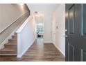 Inviting foyer with hardwood floors, staircase, and open view to living area, creating a welcoming entrance at 2039 Wildflower Nw Way, Conyers, GA 30012